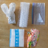 Items made of plastic film on a countertop, including bubble wrap, an Amazon mailer, and a ziptop bag