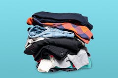 A stack of sweatshirts, sweaters, and other clothing on a blue background