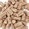 Close-up of a pile of clean wine corks with images of grapes, leaves, and stemware
