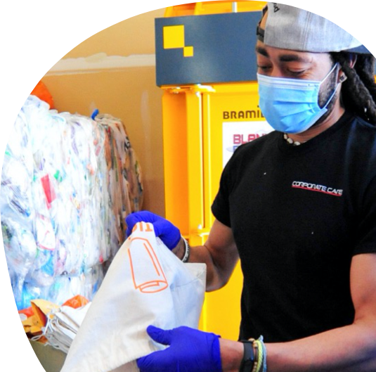 A ridwell warehouse employee sorting through recyclables