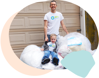 Ridwell Founder Ryan and his son Owen standing with a pile of bags to recycle